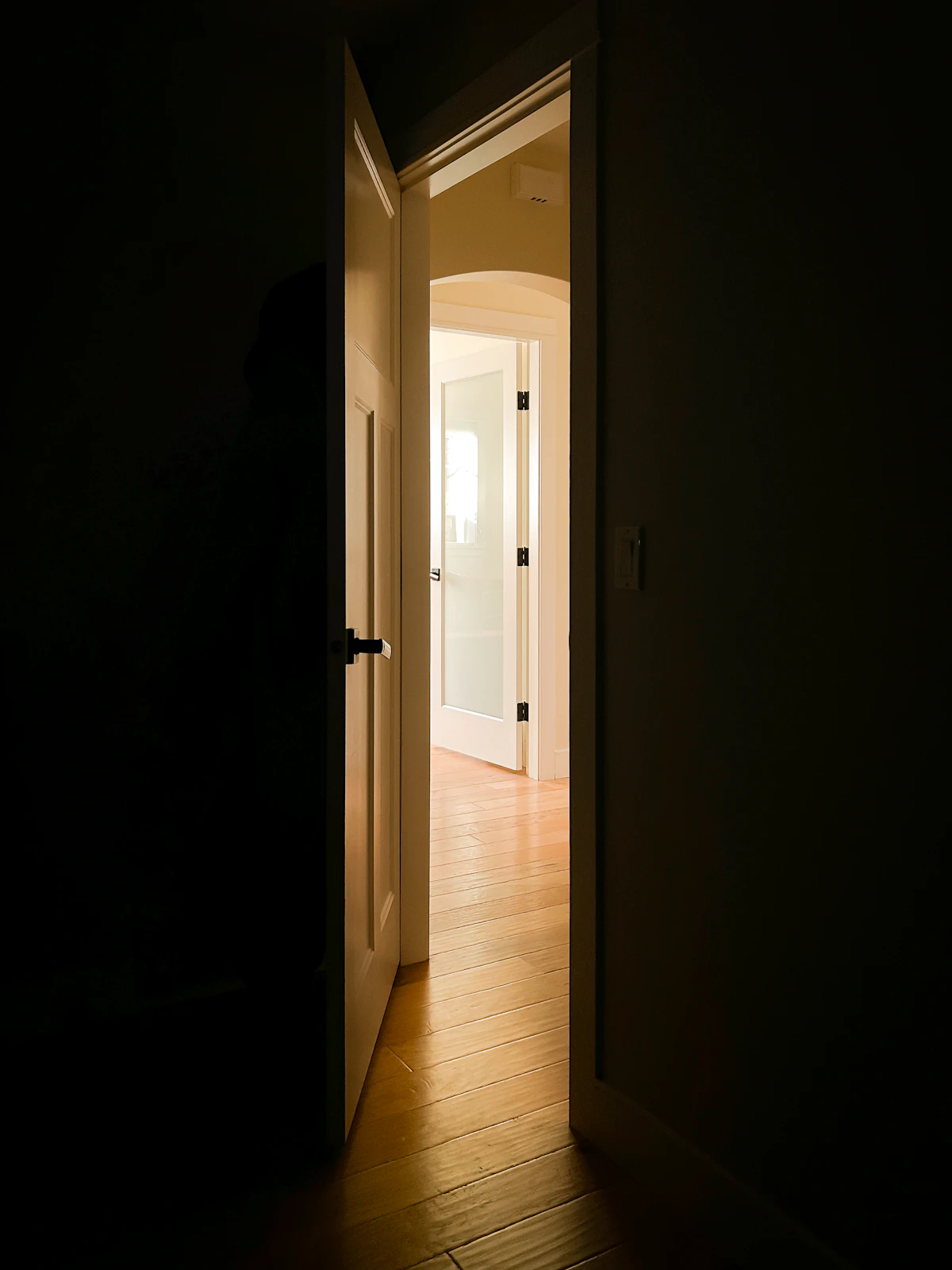 Open door to a lit hallway
